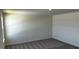Cozy bedroom featuring soft carpeting and a window with neighborhood views at 921 Emmer St, Rolesville, NC 27571