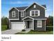 Charming two-story home featuring a neutral gray exterior with white trim and a welcoming front porch at 921 Emmer St, Rolesville, NC 27571