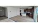 An open-concept living space connects a bright living room to a kitchen with brown cabinets at 921 Emmer St, Rolesville, NC 27571