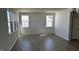 Bright living room featuring hardwood floors and multiple windows, providing lots of natural light at 921 Emmer St, Rolesville, NC 27571