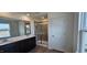 Bathroom with double vanity, tiled shower, and dark wood cabinets at 937 Emmer St, Rolesville, NC 27571