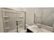 Modern bathroom features a glass-enclosed shower, white vanity, and chrome fixtures at 937 Emmer St, Rolesville, NC 27571