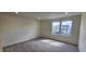 Spacious bedroom with plush carpeting and a bright window offering neighborhood views at 937 Emmer St, Rolesville, NC 27571