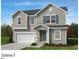 Charming two-story home featuring a welcoming front porch, attached garage, and classic design at 937 Emmer St, Rolesville, NC 27571
