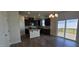 Bright eat-in kitchen with dark cabinets, granite counters, island, and sliding door at 937 Emmer St, Rolesville, NC 27571