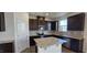 Modern kitchen with dark wood cabinets, stainless steel appliances, and an island at 937 Emmer St, Rolesville, NC 27571
