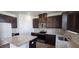 Well-lit kitchen featuring dark cabinetry, granite countertops and stainless steel appliances at 937 Emmer St, Rolesville, NC 27571