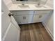 Bathroom featuring a double sink vanity with sleek, white cabinets and modern hardware at 98 Willow Cameron Way, Angier, NC 27501