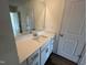 Bathroom vanity featuring a quartz countertop, modern faucet, and bright lighting at 98 Willow Cameron Way, Angier, NC 27501