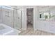 Modern bathroom featuring double vanity, a glass shower, and a walk-in closet with shelving at 98 Willow Cameron Way, Angier, NC 27501