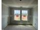 Unfinished bedroom featuring sheetrock, flooring, and natural light from multiple windows at 98 Willow Cameron Way, Angier, NC 27501