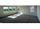 Sunny bedroom with carpeted floors and plenty of natural light from the many windows at 98 Willow Cameron Way, Angier, NC 27501