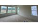 Bright bedroom featuring neutral paint, base trim, and window views to the outdoors at 98 Willow Cameron Way, Angier, NC 27501