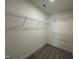 Walk-in closet featuring wire shelving for organized storage of clothing items at 98 Willow Cameron Way, Angier, NC 27501