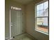 Home entryway featuring a white door with glass detailing and a bright window showcasing the outdoors at 98 Willow Cameron Way, Angier, NC 27501