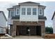 New construction home featuring a brick facade, attached garage, and modern architectural details at 98 Willow Cameron Way, Angier, NC 27501
