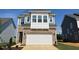 Charming two-story home with brick and blue siding and a spacious two-car garage at 98 Willow Cameron Way, Angier, NC 27501