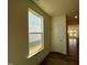 Bright hallway featuring a window and door, leading into an open-concept living space at 98 Willow Cameron Way, Angier, NC 27501