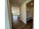 Bright hallway featuring beautiful wood flooring, leading into an open-concept living space at 98 Willow Cameron Way, Angier, NC 27501