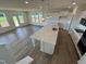 Open-concept kitchen with an island, stainless steel appliances, and bright, airy living area at 98 Willow Cameron Way, Angier, NC 27501