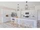 Bright kitchen featuring white cabinetry, a large center island, modern appliances, and pendant lighting at 98 Willow Cameron Way, Angier, NC 27501