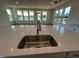 Modern kitchen with stainless steel sink, faucet, and beautiful quartz countertop with views to the outside at 98 Willow Cameron Way, Angier, NC 27501
