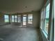 Bright, open-concept living room with large windows offering plenty of natural light at 98 Willow Cameron Way, Angier, NC 27501