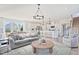 Spacious living room with abundant natural light, stylish furniture, and an open layout to the kitchen at 98 Willow Cameron Way, Angier, NC 27501