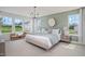 Well-lit primary bedroom with a large bed, bench, and neutral decor for a relaxing atmosphere at 98 Willow Cameron Way, Angier, NC 27501