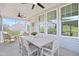 Comfortable screened porch with seating, ceiling fans, and a view of the backyard at 98 Willow Cameron Way, Angier, NC 27501