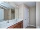 Features a double sink vanity with modern fixtures and a large mirror at 9805 Precious Stone Dr, Wake Forest, NC 27587