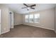 Spacious bedroom with neutral carpet, a ceiling fan, and bright windows at 9805 Precious Stone Dr, Wake Forest, NC 27587