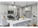 Bright kitchen with an island, bar stools, and modern fixtures and plenty of counter space at 53 Merele Dr, Wendell, NC 27591