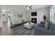 Cozy living room featuring a fireplace, contemporary furnishings, and ample natural light at 53 Merele Dr, Wendell, NC 27591