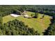 An aerial view showcases this sprawling estate with lush greenery and mature trees at 1018 Terrell Woods Ln, Chapel Hill, NC 27516