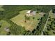 Aerial view showcasing a complete horse farm with lush pastures and facilities at 1018 Terrell Woods Ln, Chapel Hill, NC 27516
