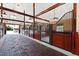 Well-maintained barn interior with brick flooring, wood beams, and multiple horse stalls at 1018 Terrell Woods Ln, Chapel Hill, NC 27516