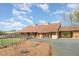 A well-maintained barn with an orange door sits on a sprawling, landscaped property at 1018 Terrell Woods Ln, Chapel Hill, NC 27516