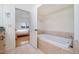 Bathroom featuring a soaking tub and view to an adjacent bedroom at 1018 Terrell Woods Ln, Chapel Hill, NC 27516