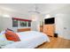 Bright bedroom with a king bed, ceiling fan, and view into attached bath at 1018 Terrell Woods Ln, Chapel Hill, NC 27516