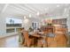 Bright dining space with a wooden table, setting for six, and flows into the modern kitchen and features natural light at 1018 Terrell Woods Ln, Chapel Hill, NC 27516