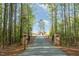 Long gravel driveway leads to a private estate surrounded by a lush green forest at 1018 Terrell Woods Ln, Chapel Hill, NC 27516