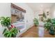 Bright entryway with hardwood floors and large windows bringing the outdoors in with various plant life at 1018 Terrell Woods Ln, Chapel Hill, NC 27516