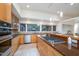 Well-appointed kitchen featuring custom cabinets, stone countertops, and modern appliances with open sightlines to the dining area at 1018 Terrell Woods Ln, Chapel Hill, NC 27516