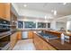 Open kitchen with stainless steel appliances, granite countertops, and sleek cabinetry at 1018 Terrell Woods Ln, Chapel Hill, NC 27516