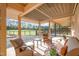 A cozy covered patio with a seating area overlooks a sprawling, grassy property at 1018 Terrell Woods Ln, Chapel Hill, NC 27516