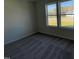 Bedroom with carpet and a large window with an exterior view at 111 Magnolia Run Way, Benson, NC 27504