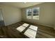 Bright bedroom with light wood grain vinyl flooring and a window at 111 Magnolia Run Way, Benson, NC 27504