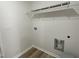 Simple laundry room features a wire shelf and tile flooring at 111 Magnolia Run Way, Benson, NC 27504