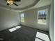 Main bedroom has tray ceilings, a ceiling fan, and two bright windows at 111 Magnolia Run Way, Benson, NC 27504